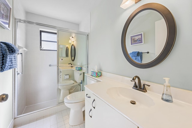 bathroom featuring tile patterned flooring, vanity, toilet, and a shower with door