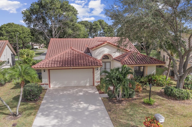 mediterranean / spanish home with a garage and a front yard