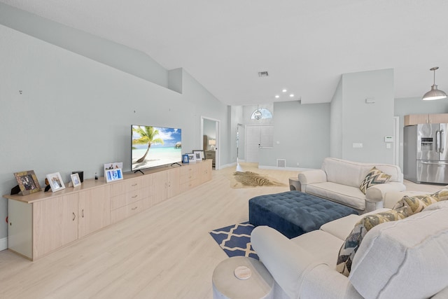 living room featuring light wood-type flooring and lofted ceiling