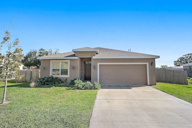 view of front of home with a garage and a front lawn