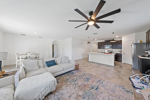 living room with light tile patterned floors and ceiling fan