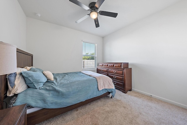 bedroom with light carpet, vaulted ceiling, and ceiling fan