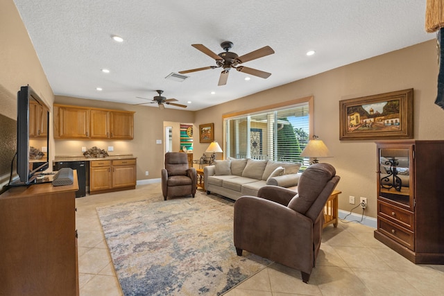 tiled living room with ceiling fan and a textured ceiling