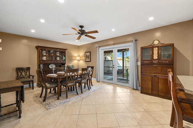 tiled dining space featuring ceiling fan