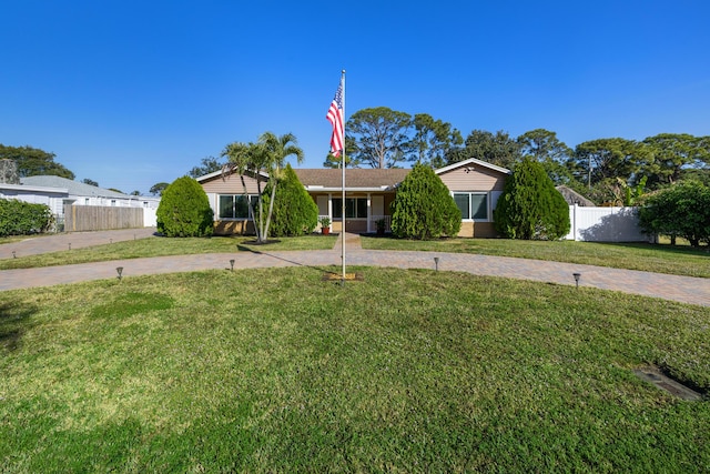 ranch-style house with a front lawn