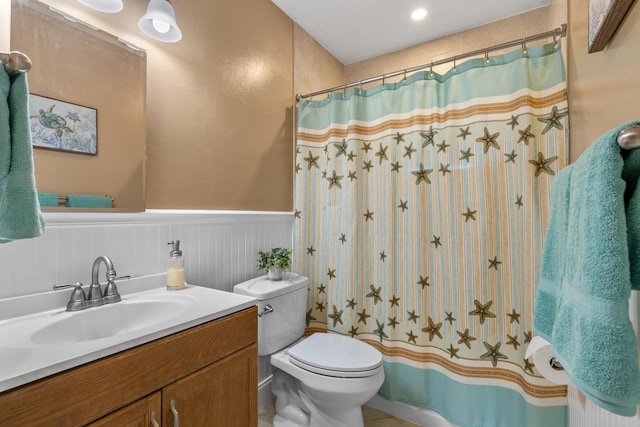 bathroom with a shower with shower curtain, vanity, toilet, and tile patterned floors