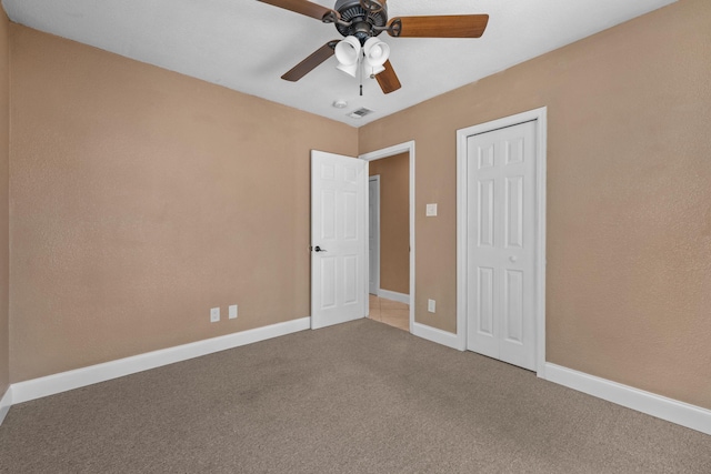 unfurnished bedroom with carpet floors, a closet, and ceiling fan