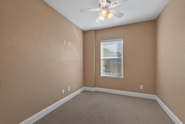 spare room featuring carpet flooring and ceiling fan