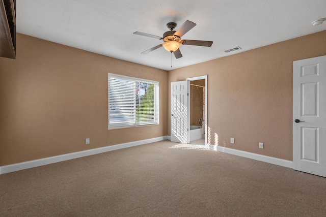 unfurnished bedroom featuring connected bathroom, ceiling fan, and light carpet