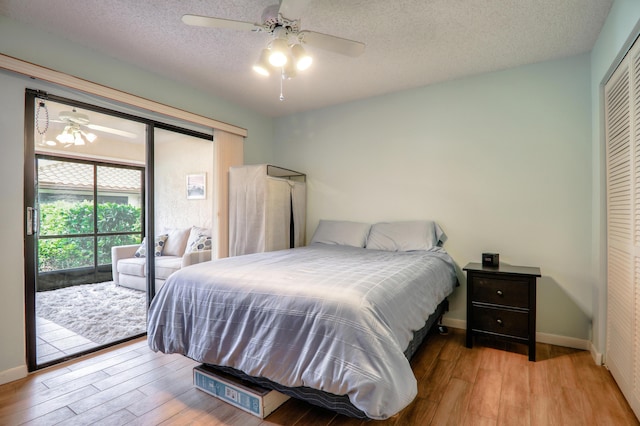 bedroom featuring ceiling fan, a closet, a textured ceiling, and light wood-type flooring