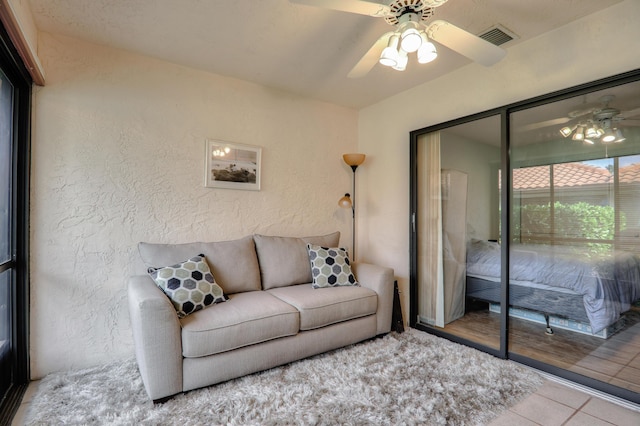 living room featuring ceiling fan and light hardwood / wood-style flooring