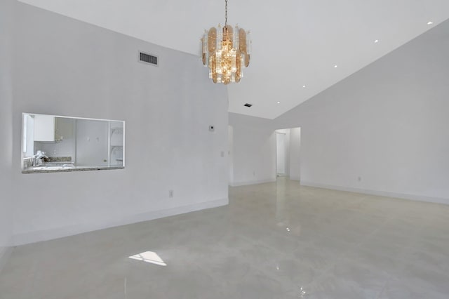 unfurnished living room with high vaulted ceiling and a notable chandelier