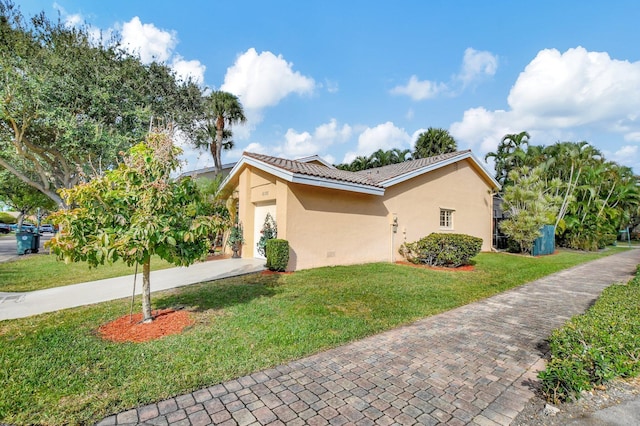 view of side of property with a lawn