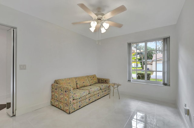 sitting room featuring tile patterned floors and ceiling fan