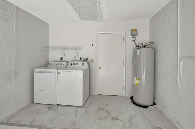 washroom with washer and clothes dryer, electric water heater, and a textured ceiling