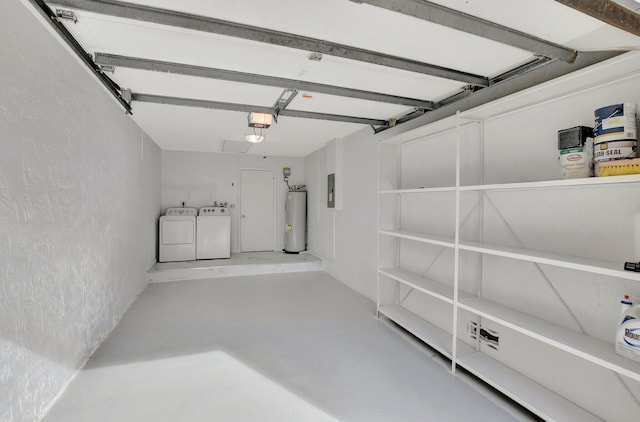 garage featuring electric water heater, electric panel, independent washer and dryer, and a garage door opener