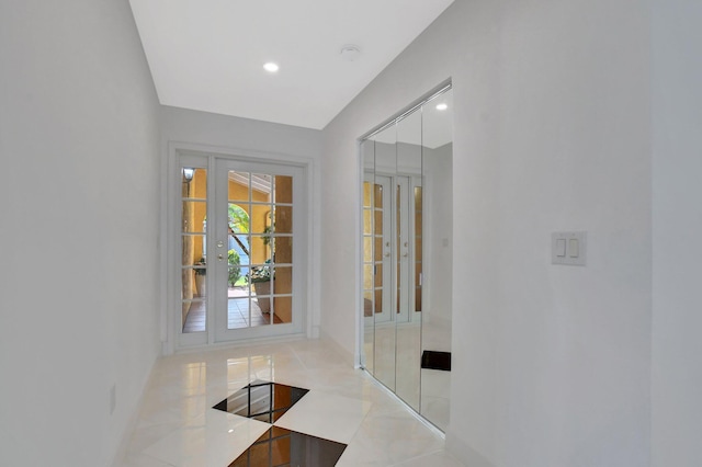 doorway with light tile patterned floors