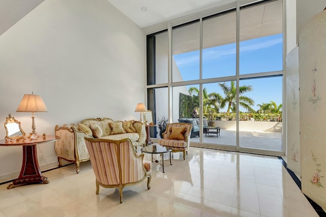 interior space featuring expansive windows, a towering ceiling, and a wealth of natural light