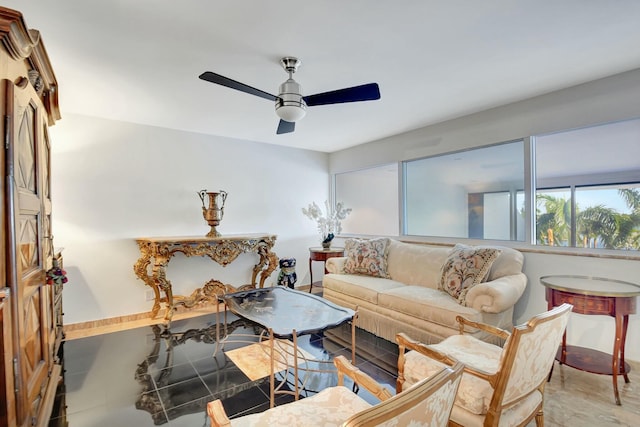 living room with ceiling fan and baseboards