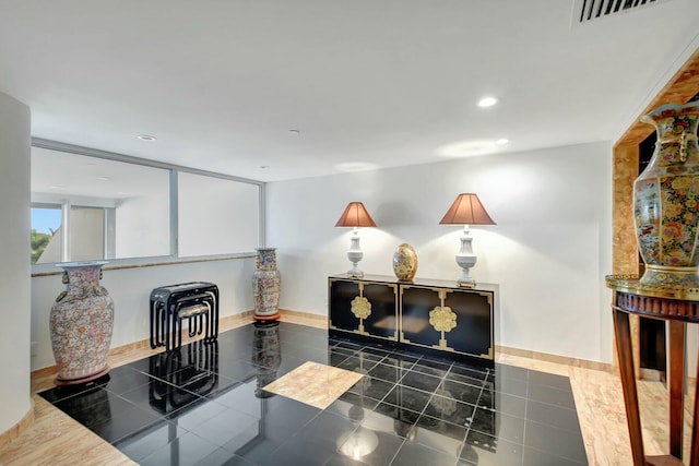 interior space featuring recessed lighting, visible vents, baseboards, and dark tile patterned flooring