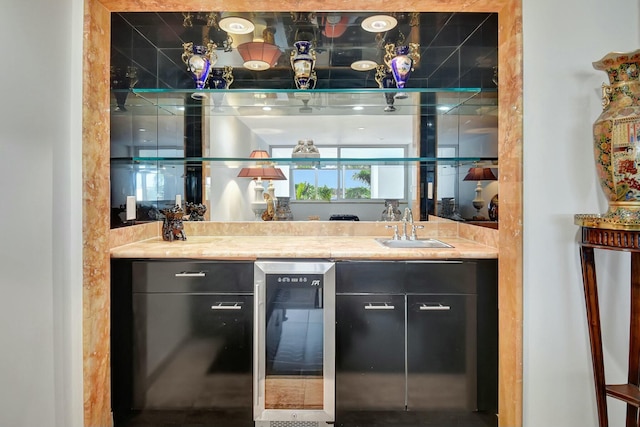 bar with wine cooler, a sink, and wet bar