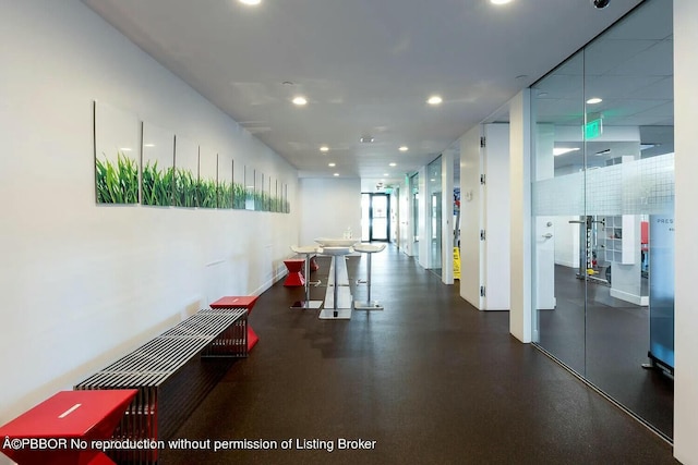 hallway with baseboards and recessed lighting