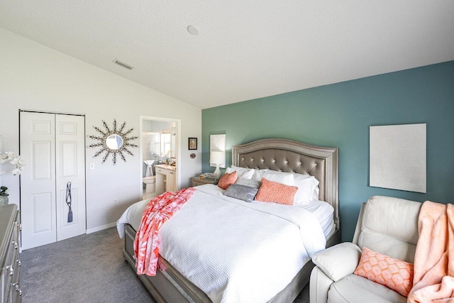 carpeted bedroom featuring vaulted ceiling, ensuite bath, and a closet