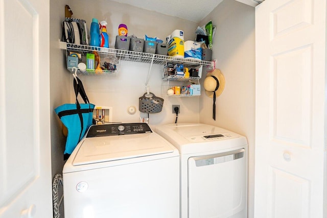 clothes washing area with separate washer and dryer