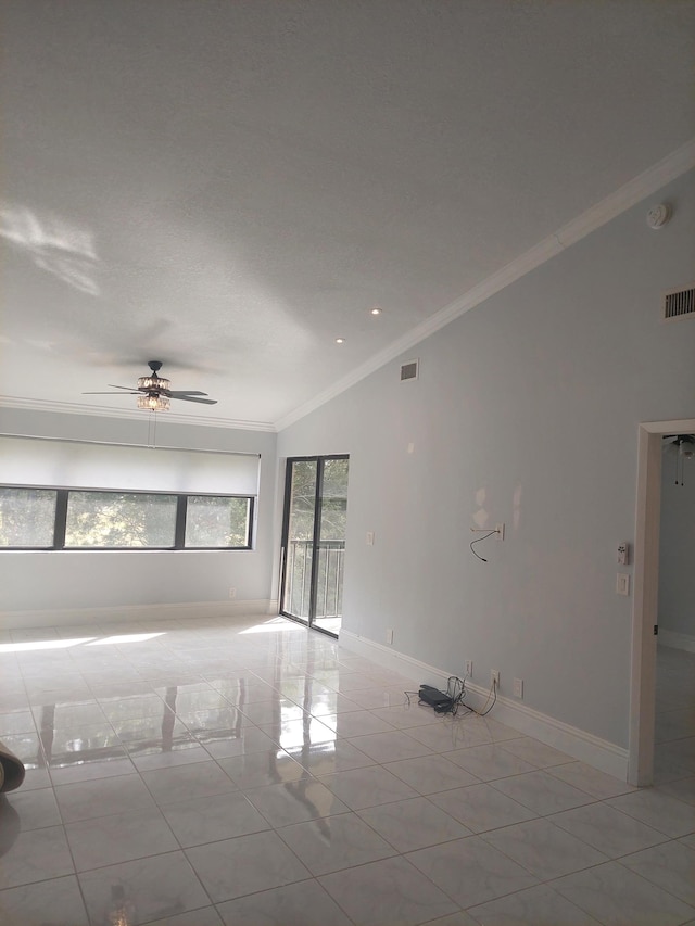 tiled empty room featuring ceiling fan, lofted ceiling, and crown molding