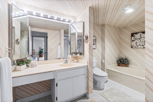 bathroom with tile patterned flooring, vanity, toilet, and a tub to relax in