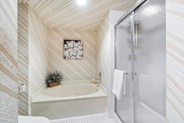 bathroom featuring shower with separate bathtub