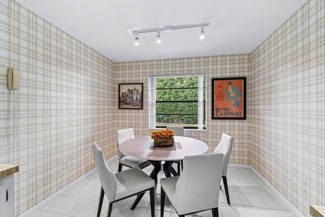 dining space featuring light tile patterned floors and rail lighting