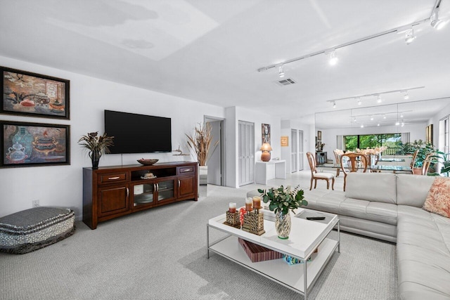 living room with light colored carpet and rail lighting