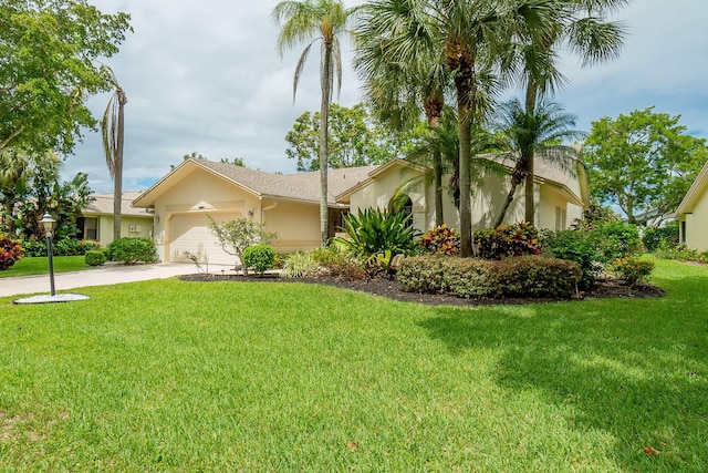 view of front of property featuring a front lawn and a garage