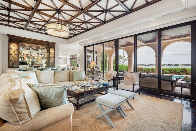 living room featuring coffered ceiling, crown molding, indoor bar, hardwood / wood-style flooring, and a chandelier