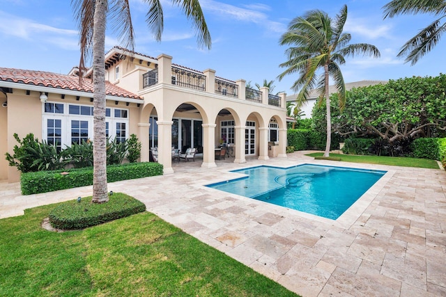 view of swimming pool with a lawn and a patio