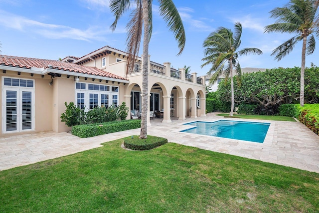 view of pool featuring a patio area and a yard