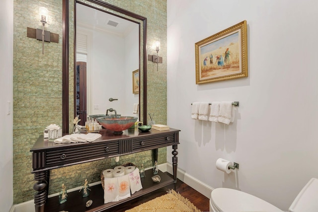 bathroom with hardwood / wood-style floors, vanity, toilet, and ornamental molding