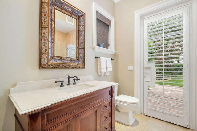 bathroom featuring tile patterned floors, vanity, and toilet