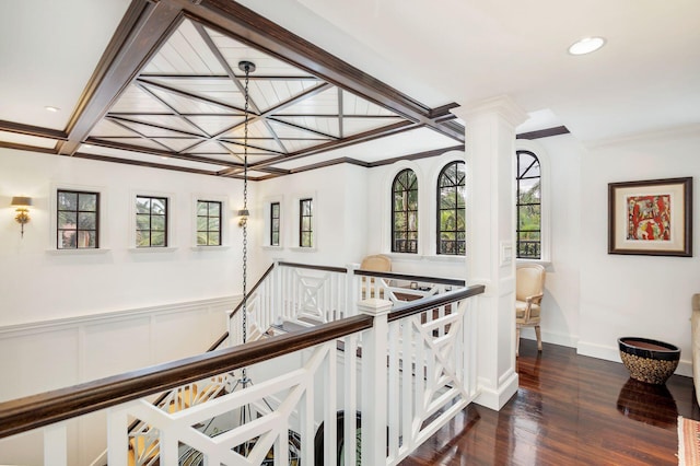 corridor with dark hardwood / wood-style flooring, a wealth of natural light, crown molding, and coffered ceiling