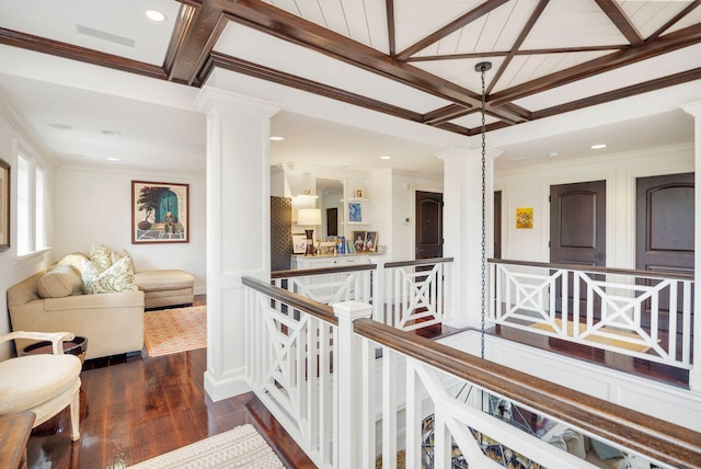 hall featuring ornate columns, dark wood-type flooring, coffered ceiling, beamed ceiling, and crown molding