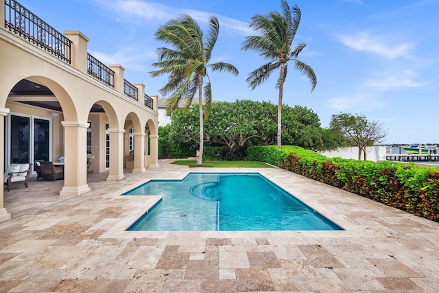 view of swimming pool featuring a patio area