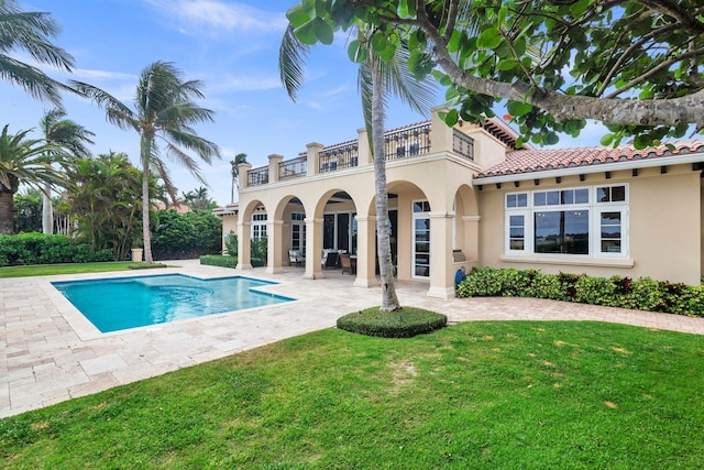 view of swimming pool with a patio area and a lawn