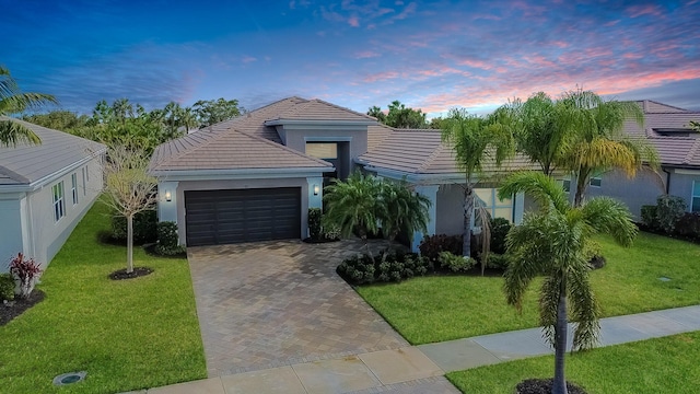 view of front facade with a garage and a yard