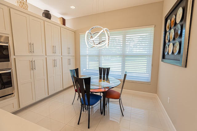 tiled dining space with a wealth of natural light and an inviting chandelier