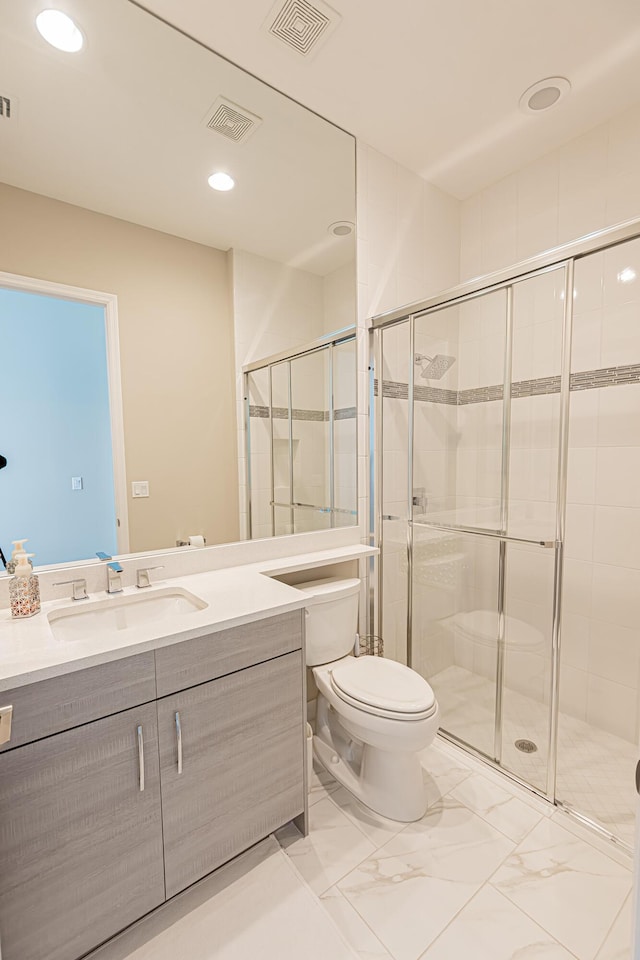 bathroom featuring vanity, toilet, and walk in shower