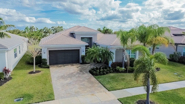 view of front of house with a front yard and a garage