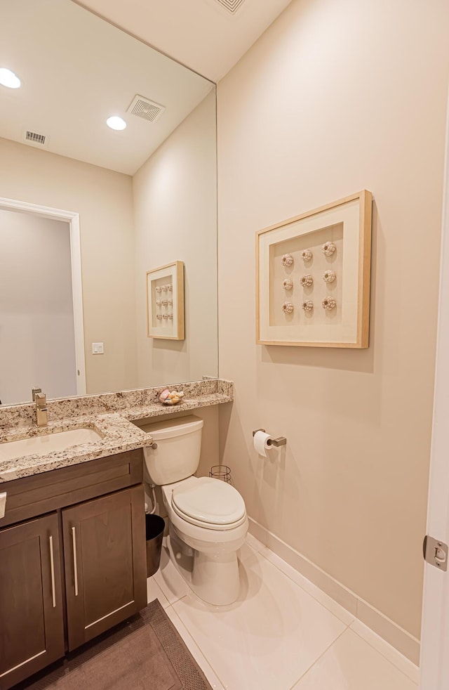 bathroom featuring tile patterned floors, vanity, and toilet