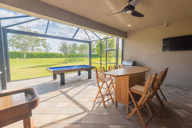 view of patio with ceiling fan and a lanai