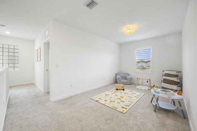 sitting room featuring light carpet